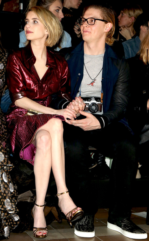 Emma Roberts And Evan Peters Hold Hands While Sitting Front Row At